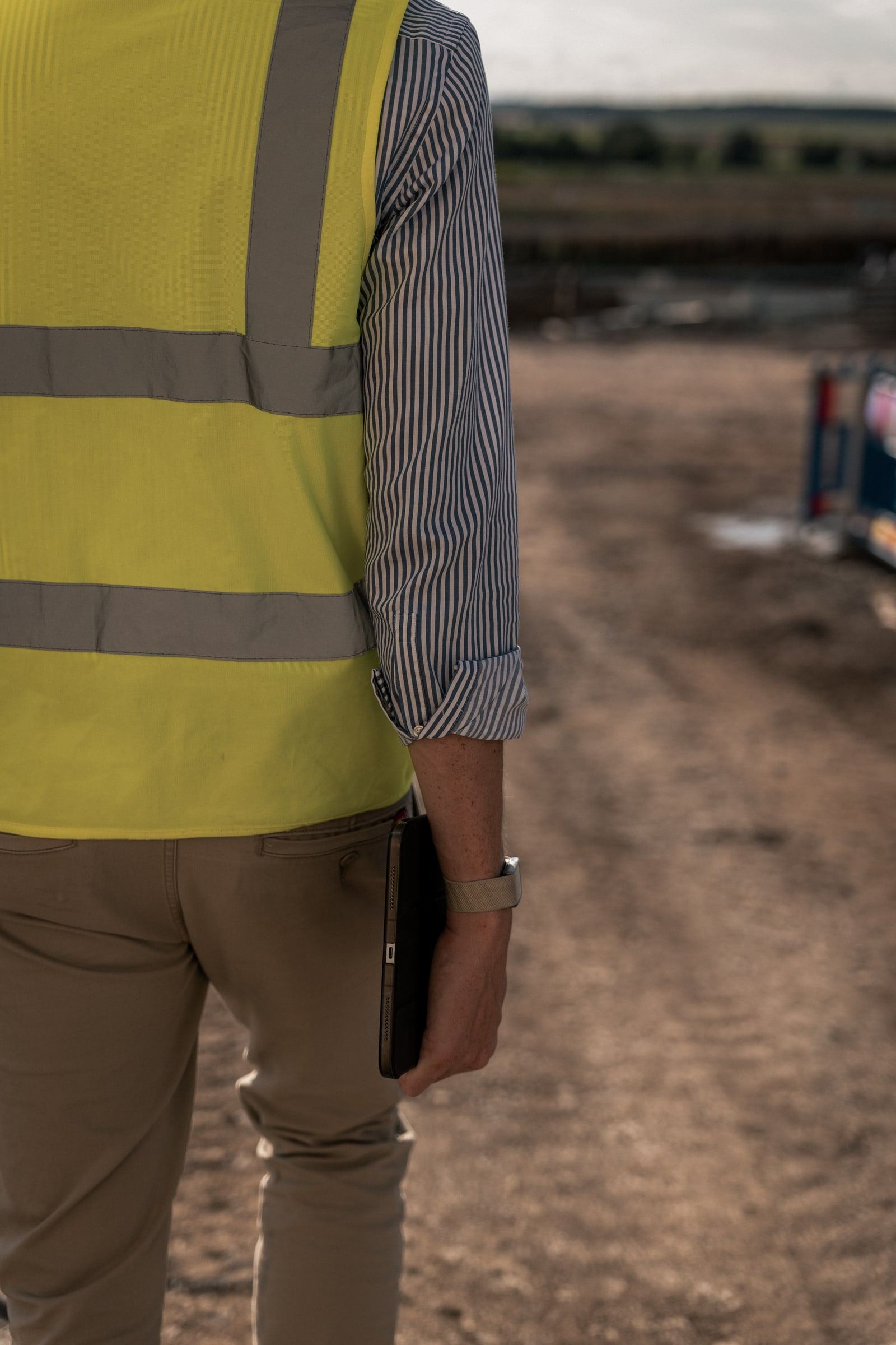 Andreas Postler in a hi-vis vest on a site road, tablet in hand